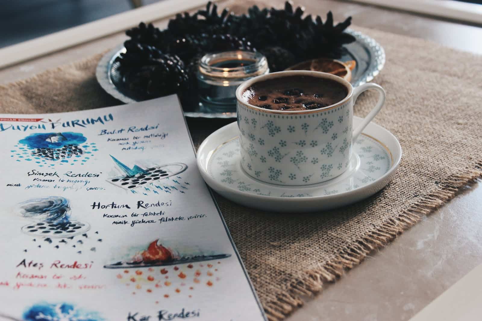 Coffee Cup And Christmas Decoration On Table